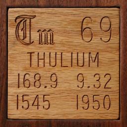 Wooden tile representing the elementThulium